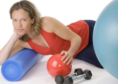 Fitness instructor lies with equipment in posed promotional photo