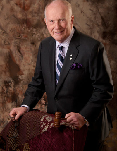 In studio portrait of older professional holding a gavel