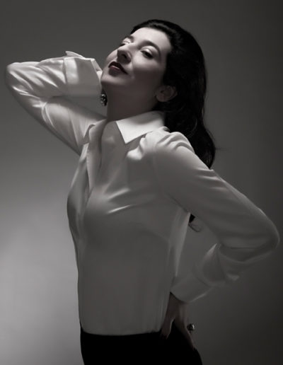 Dramtic portrait of woman in white blouse in studio