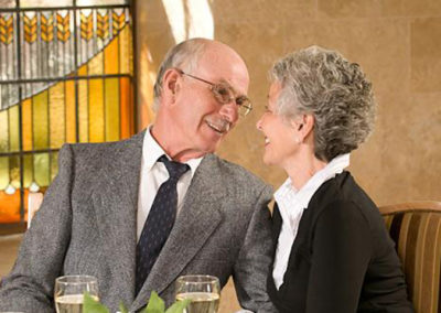 Older couple shares a moment while dining out in on location portrait
