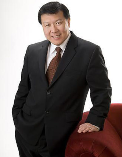Chinese business man poses in studio with white background
