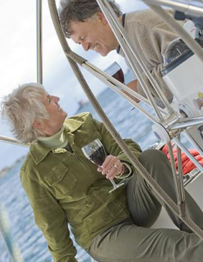 Older couple enjoys a drink while sailing