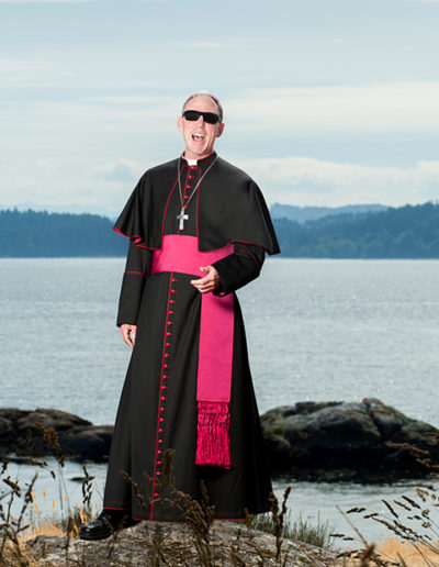 Catholic bishop poses for fun portrait with sunglasses on outdoor on location photo shoot