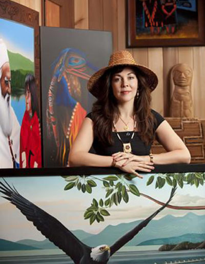 On location portrait of aboriginal first nations artist in her home with artwork