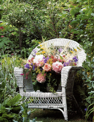 Detail photo of flowers sitting on a wicker chair