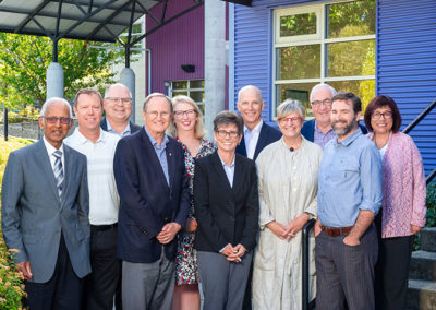 Group of board members pose for on location group photo