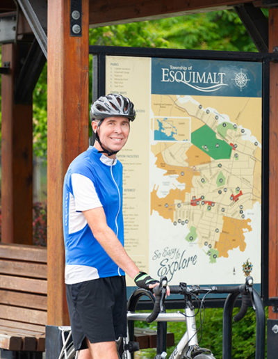 Active man stands with his bike in Esquimalt