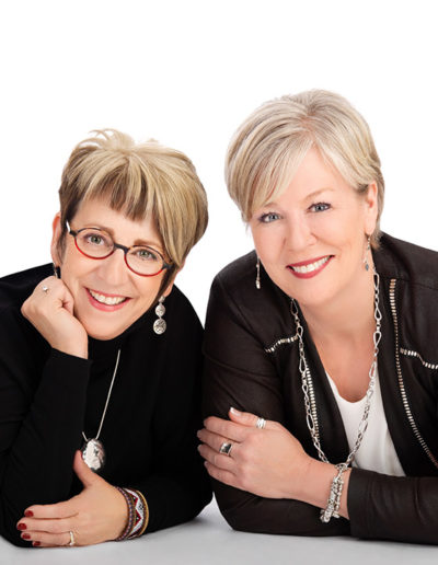 Two business partners pose for studio portrait