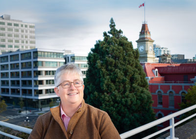 City councilor poses for on location headshot in downtown Victoria